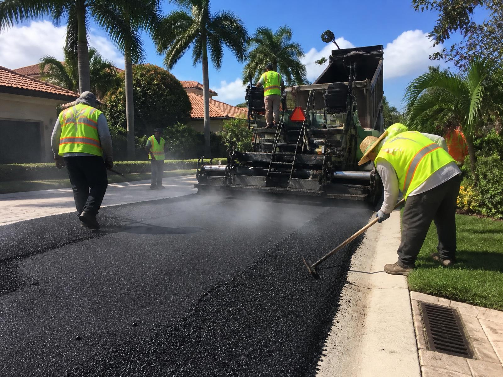 South Florida Paving Inc. crew placing hot mix asphalt on a commercial project